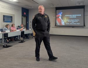 Officer Bruce Beardsley speaking in front of his presentation slides